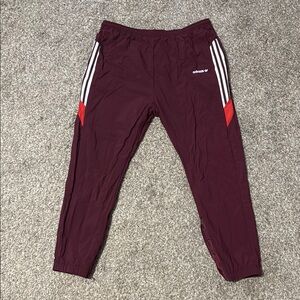 Adidas Red Sweatpants with Tapered Fit and Iconic Stripes